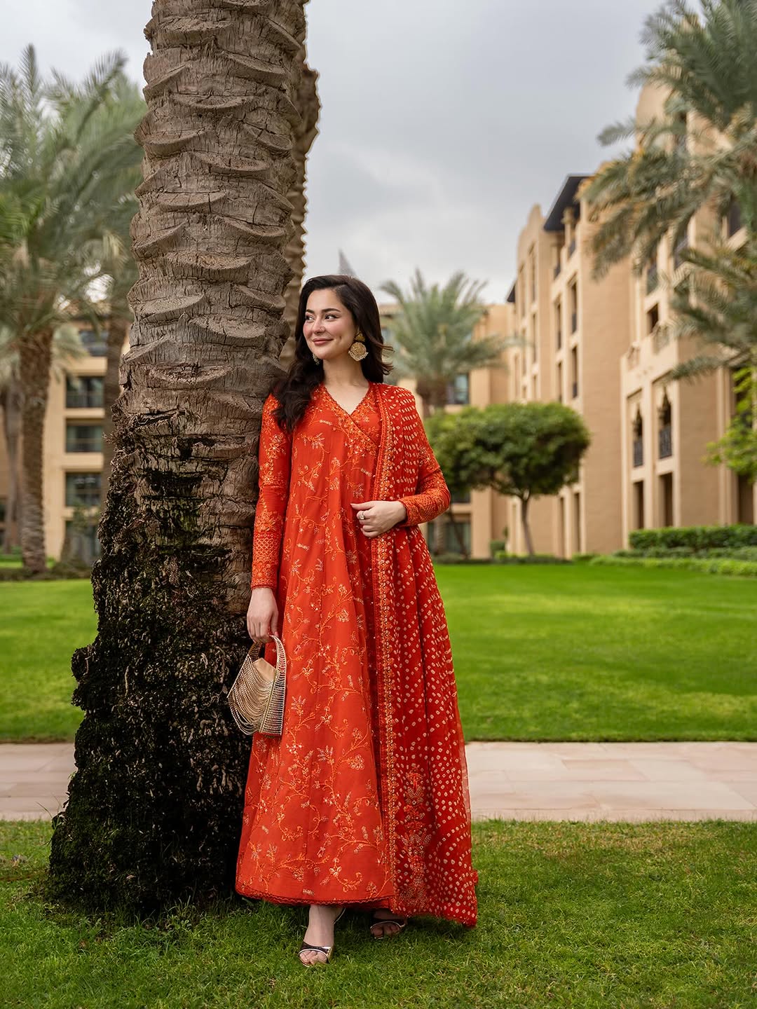 Hania Amir Wearing Orange Pishwas Anarkali Dress Denisa from Faiza Saqlain Aya Luxury Lawn - Front look - Available for women in UK and USA.