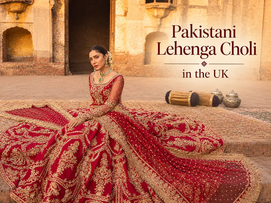 British Asian woman in a red and gold embroidered lehenga choli with a net dupatta at a UK wedding reception.